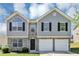 Charming two-story home with stone accents, black shutters, and a two-car garage at 2590 Carolina Rdg, Riverdale, GA 30296