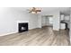 Open living room featuring hardwood floors, a fireplace, and seamless access to the kitchen area at 2590 Carolina Rdg, Riverdale, GA 30296