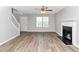 Spacious living room featuring wood flooring, fireplace, and staircase at 2590 Carolina Rdg, Riverdale, GA 30296