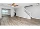 Open living room with wood-look flooring, leading to the kitchen and staircase at 2590 Carolina Rdg, Riverdale, GA 30296