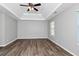 Expansive main bedroom with tray ceiling, ceiling fan, natural light, and wood-look flooring at 2590 Carolina Rdg, Riverdale, GA 30296