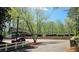 A lushly landscaped front property view with mature trees and a car in the driveway at 2929 Torreya Se Way, Marietta, GA 30067