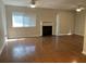 Bright living room featuring hardwood floors, a fireplace, and a large window with natural light at 2929 Torreya Se Way, Marietta, GA 30067