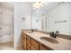 Double sink bathroom featuring granite countertop, wood cabinets, and separate shower at 5658 Greensage Dr, Atlanta, GA 30349