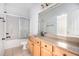 Bathroom with a shower over the tub, and a wood vanity with a granite countertop at 5658 Greensage Dr, Atlanta, GA 30349
