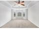 A spacious bedroom with bay windows, tray ceilings, carpet floors, and plenty of natural light at 5658 Greensage Dr, Atlanta, GA 30349