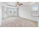 A spacious bedroom with bay windows, tray ceilings, carpet floors, and plenty of natural light at 5658 Greensage Dr, Atlanta, GA 30349