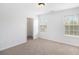 Bedroom with neutral carpet, bright natural light, and a walk-in closet at 5658 Greensage Dr, Atlanta, GA 30349