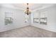 Elegant dining room with carpeted floors, decorative molding, and a chandelier at 5658 Greensage Dr, Atlanta, GA 30349