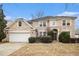 Charming two-story brick home with attached garage, manicured landscaping, and inviting entrance at 5658 Greensage Dr, Atlanta, GA 30349