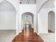 Bright foyer featuring hardwood floors, white walls, and arched doorways at 5658 Greensage Dr, Atlanta, GA 30349