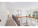 Upstairs hallway with wood and iron railing at 5658 Greensage Dr, Atlanta, GA 30349