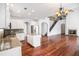 Open kitchen featuring stainless appliances, granite counters, kitchen island and hardwood floors at 5658 Greensage Dr, Atlanta, GA 30349