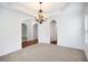 Inviting living room with carpet, chandelier, and decorative archways at 5658 Greensage Dr, Atlanta, GA 30349
