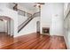 Open-concept living room featuring hardwood floors, fireplace, and a staircase at 5658 Greensage Dr, Atlanta, GA 30349