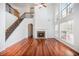 Bright living room with fireplace, hardwood floors, and an adjacent staircase at 5658 Greensage Dr, Atlanta, GA 30349