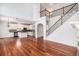 Open living space with hardwood floors, white walls, kitchen island and staircase at 5658 Greensage Dr, Atlanta, GA 30349