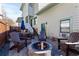 Inviting backyard with a stone fire pit, Adirondack chairs, dining set, and wooden privacy fence at 93 Hammock Se Pl, Atlanta, GA 30312