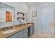 Bathroom with a double sink vanity with beautiful granite counters and decor at 93 Hammock Se Pl, Atlanta, GA 30312