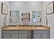 Bathroom featuring a double sink vanity with granite counters, decor, and wall-mounted shelves at 93 Hammock Se Pl, Atlanta, GA 30312