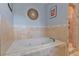 Modern bathroom with a luxurious bathtub, tiled surround, and natural light at 93 Hammock Se Pl, Atlanta, GA 30312