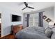Bedroom with hardwood floors and an attached TV above a dark wood dresser at 93 Hammock Se Pl, Atlanta, GA 30312