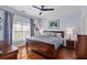 Comfortable bedroom with hardwood floors, ceiling fan and large windows at 93 Hammock Se Pl, Atlanta, GA 30312