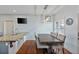 Bright dining area featuring a modern light fixture and a wooden table with seating for six at 93 Hammock Se Pl, Atlanta, GA 30312