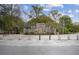 Stone structure marks the entrance, adorned with flowers and greenery, surrounded by trees at 93 Hammock Se Pl, Atlanta, GA 30312