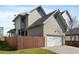 Exterior view of a house with a garage, wood fence, and concrete driveway at 93 Hammock Se Pl, Atlanta, GA 30312