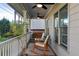 Relaxing front porch featuring comfortable seating, a swing, and ceiling fans at 93 Hammock Se Pl, Atlanta, GA 30312