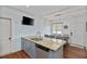 Kitchen island with granite countertop and adjacent dining area with wooden table and seating at 93 Hammock Se Pl, Atlanta, GA 30312