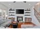 Comfortable living room featuring a fireplace, built-in shelves, and stylish decor at 93 Hammock Se Pl, Atlanta, GA 30312