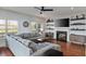 Inviting living room with a gray sectional sofa, fireplace, and large windows at 93 Hammock Se Pl, Atlanta, GA 30312
