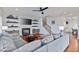 Open-concept living room with a fireplace, staircase, and hardwood floors at 93 Hammock Se Pl, Atlanta, GA 30312