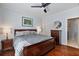 Comfortable main bedroom featuring a ceiling fan, dark-wood furnishings, and stylish decor at 93 Hammock Se Pl, Atlanta, GA 30312