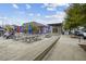 Outdoor seating area with picnic tables, string lights, and views of nearby businesses at 93 Hammock Se Pl, Atlanta, GA 30312