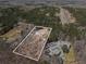 An aerial view showing the property with a treed surround and nearby housing at 9640 Cedar Grove Rd, Fairburn, GA 30213