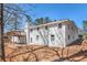Exterior view of home with brick siding, wooden deck and mature trees at 9640 Cedar Grove Rd, Fairburn, GA 30213