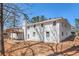 Rear view of the white brick home with windows and large deck on the second floor at 9640 Cedar Grove Rd, Fairburn, GA 30213