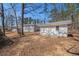 Backyard with two outbuildings and mature trees at 9640 Cedar Grove Rd, Fairburn, GA 30213