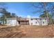 Back of home with a large deck and a chimney at 9640 Cedar Grove Rd, Fairburn, GA 30213