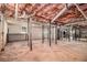 Unfinished basement space with exposed pipes, and support beams offering potential for customization at 9640 Cedar Grove Rd, Fairburn, GA 30213
