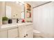 Cozy bathroom featuring white vanity with white countertop, modern fixtures, mirror and tiled shower at 9640 Cedar Grove Rd, Fairburn, GA 30213