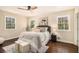 Cozy bedroom with natural light from two windows, hardwood floors, ceiling fan, and comfortable furniture at 9640 Cedar Grove Rd, Fairburn, GA 30213