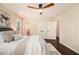 Comfortable bedroom featuring hardwood floors, large windows, ceiling fan, and closet space at 9640 Cedar Grove Rd, Fairburn, GA 30213