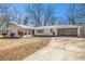Quaint white-painted home with a large driveway and attached carport at 9640 Cedar Grove Rd, Fairburn, GA 30213