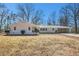 Charming single-story home with a well-maintained lawn and attached carport at 9640 Cedar Grove Rd, Fairburn, GA 30213