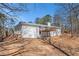 Spacious brick home with a large wooden deck overlooking the backyard and surrounded by mature trees at 9640 Cedar Grove Rd, Fairburn, GA 30213