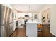 Bright kitchen features stainless steel appliances, white cabinets, and a center island with counter seating at 9640 Cedar Grove Rd, Fairburn, GA 30213